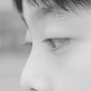 Sad child resting on hand, symbolising the impact of educational instability