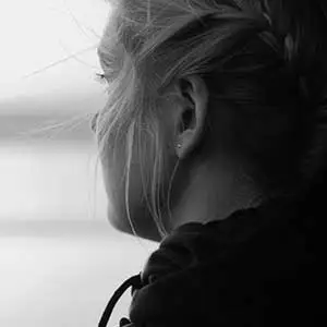 Teenager looking away, representing the lifelong consequences of early trauma